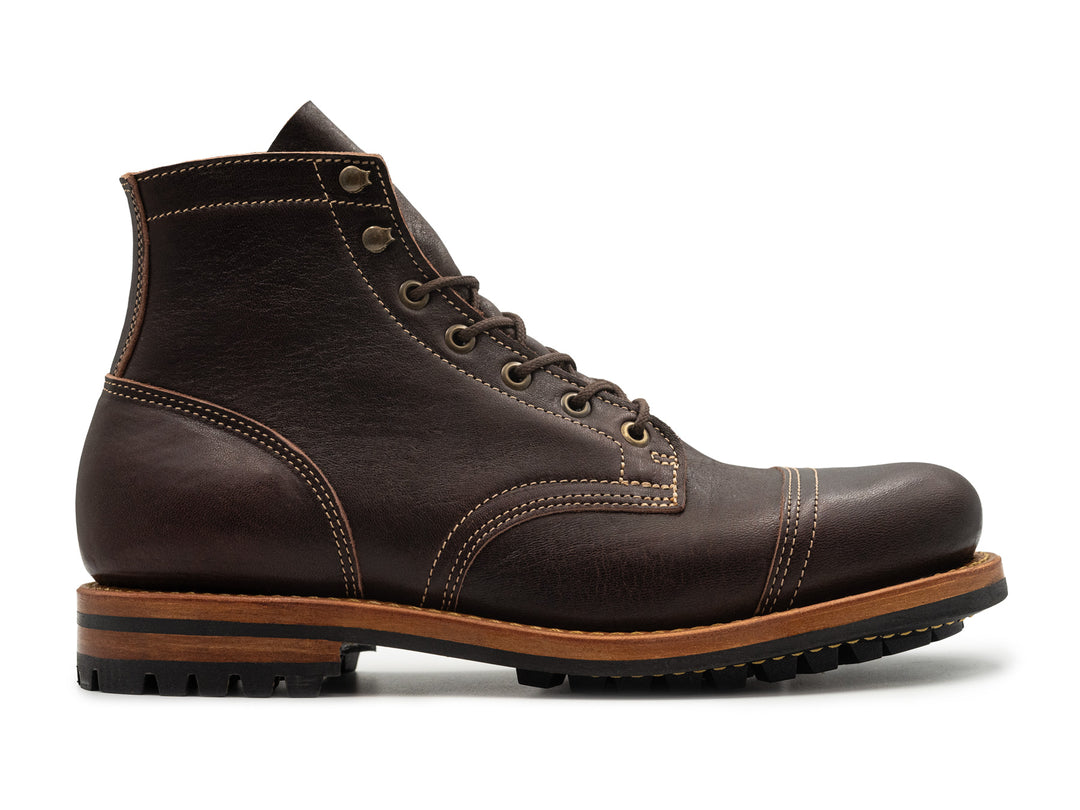 A dark brown leather lace-up ankle boot with contrast stitching, a brown midsole, and a black rubber outsole, shown in a side profile on a white background.