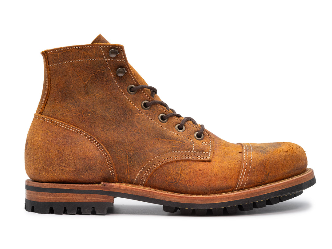 orange textured leather boot on white background