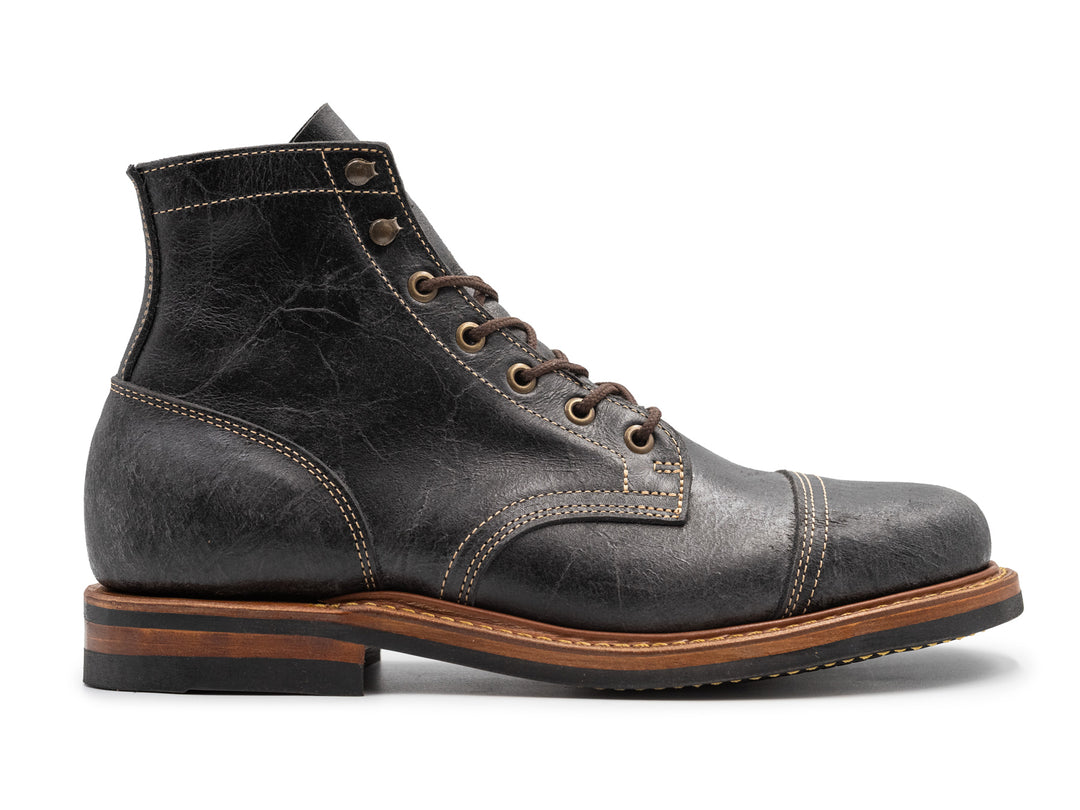gray textured leather boot in side profile view against white background