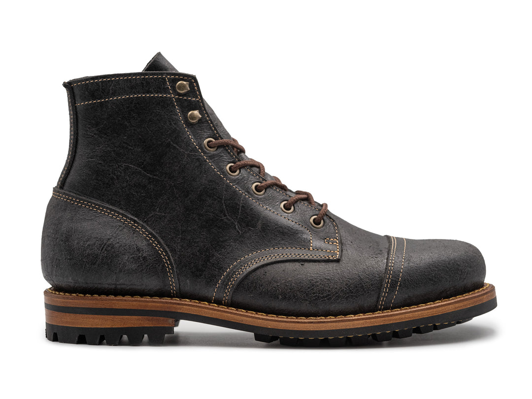textured gray leather boot on white background