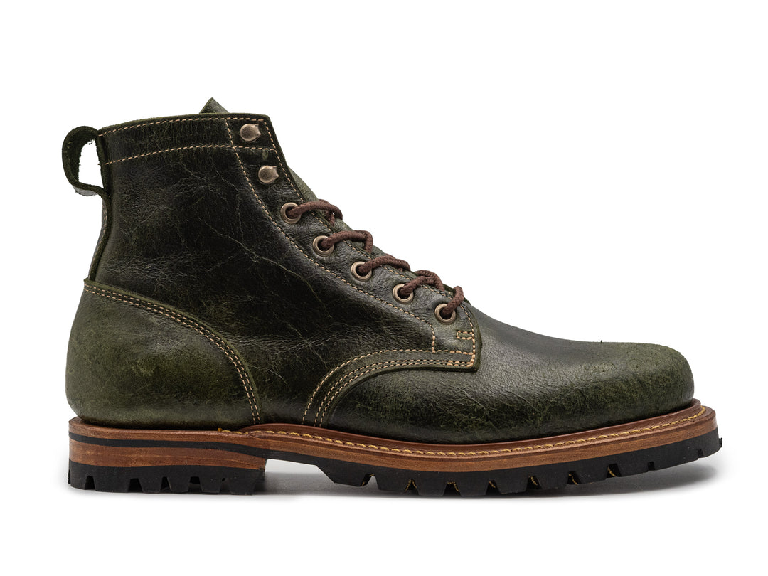 green textured leather boot on white background
