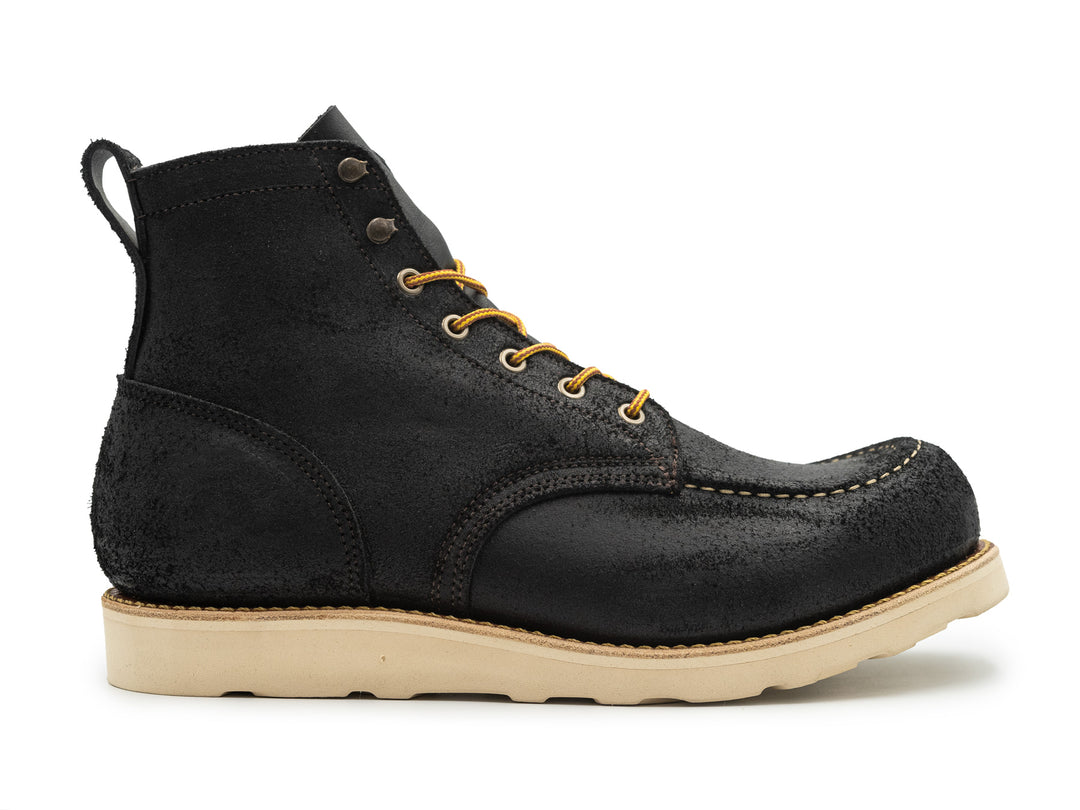 side view of black oiled rough out leather boot on white background