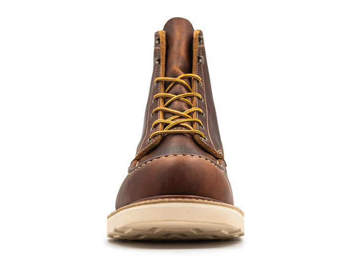 front view of rustic brown leather moc toe boot on white background
