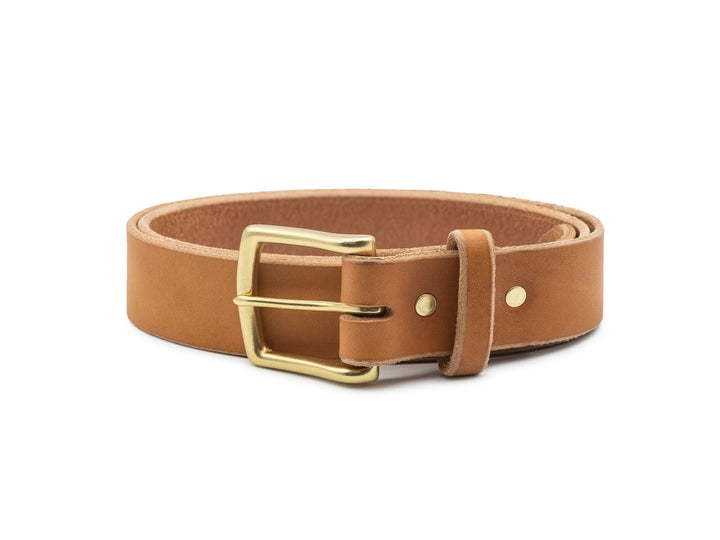 veg tan leather belt with brass buckle coiled on white background