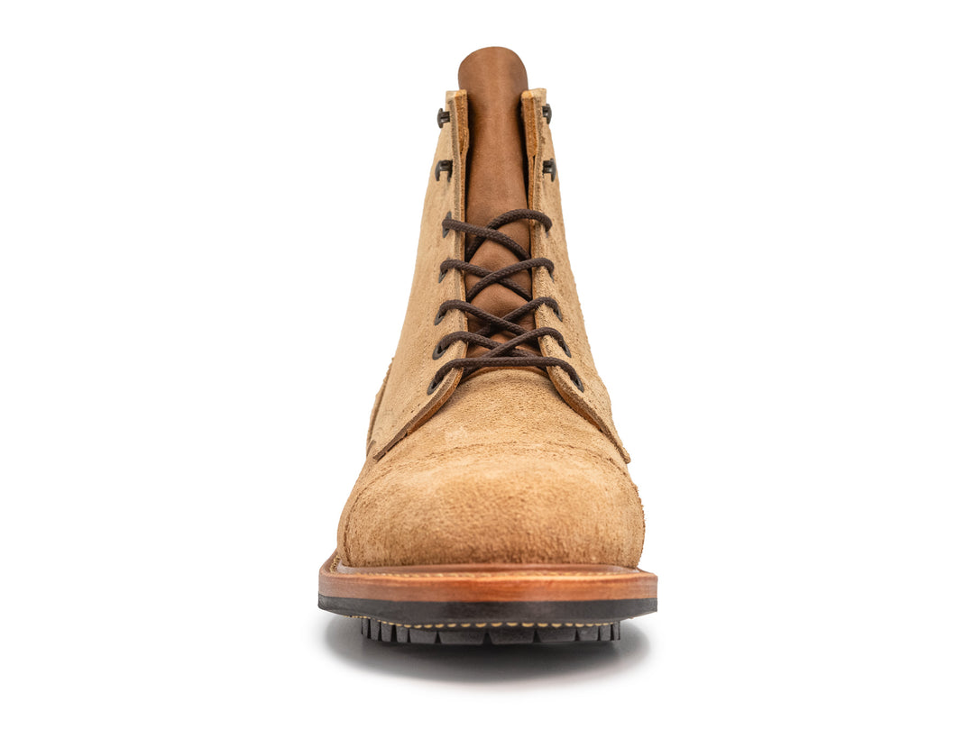 front view of tan rough out leather boot on white background